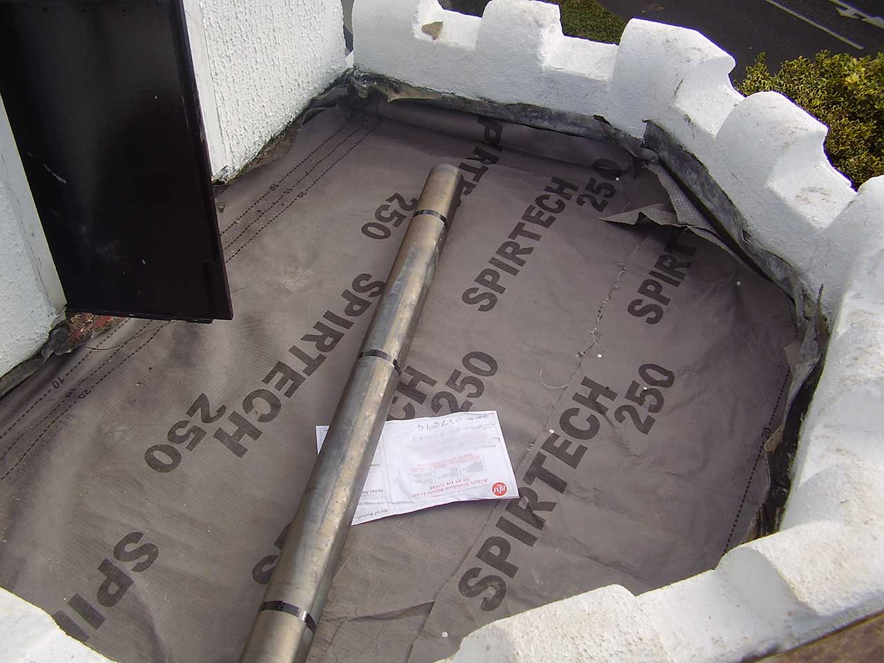 Preparing to lay lead flashing on mock-battlement style flat roof